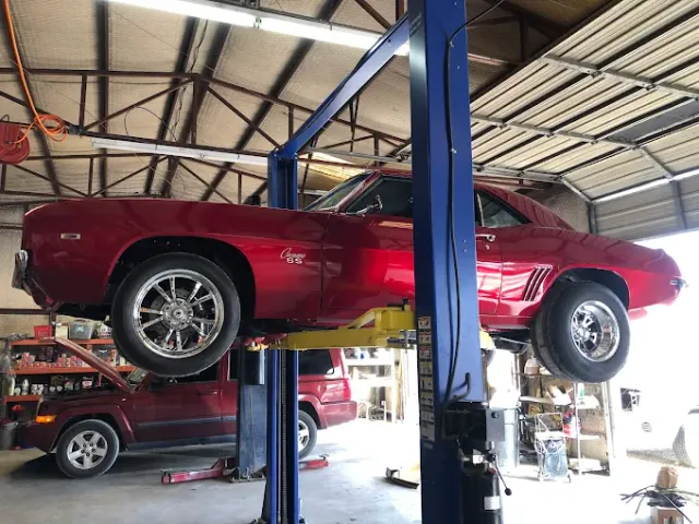 Red Camaro hot rod with Slick tires on the rear at First Choice Auto Repair in Keller, TX